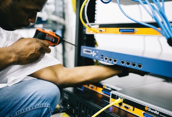 Technician installing network equipment